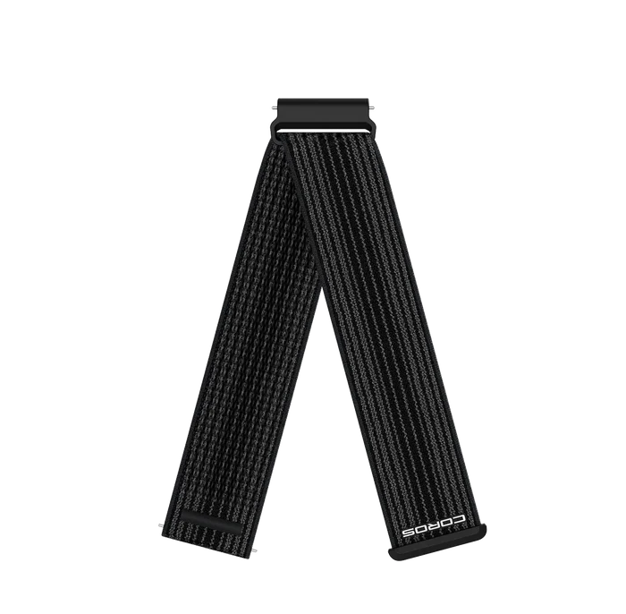 A black woven watch strap with a silver-toned metal buckle, shown in a V-shape arrangement on a plain white background. The brand name 'COROS' is printed in white near the bottom right end of the strap.