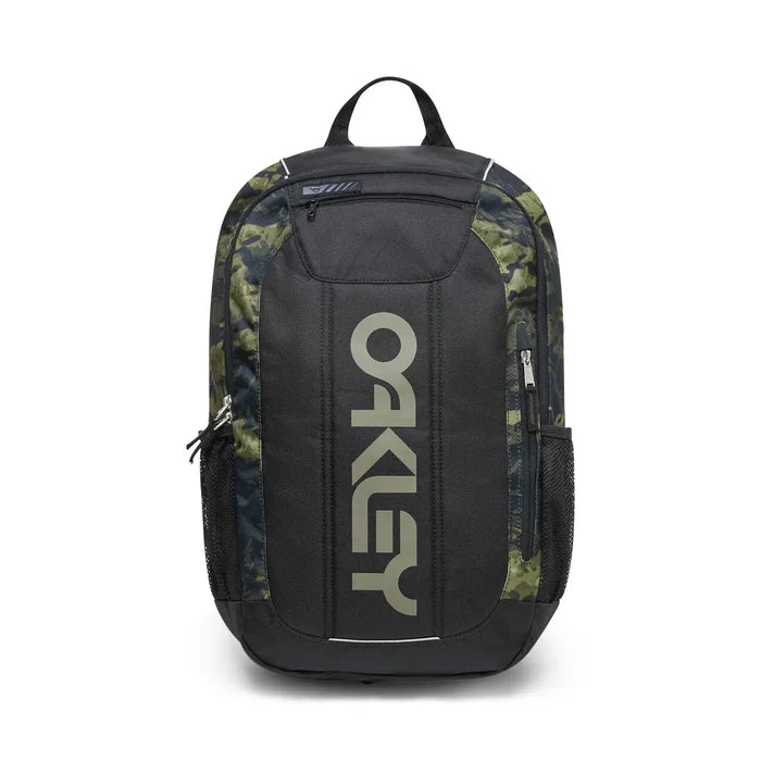 Oakley backpack in black with green and brown camouflage pattern side panels and a large vertical Oakley logo on the front.