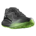 Gray running shoe with green sole on a white background